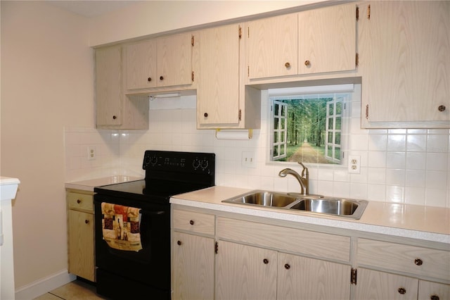 4349 Tahitian Gardens Cir Unit G, Holiday, FL 34691 - kitchen with black range with electric cooktop, a sink, light countertops, and tasteful backsplash