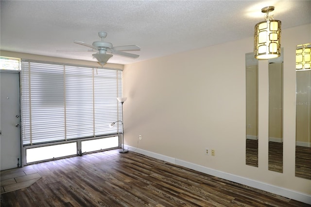 4349 Tahitian Gardens Cir Unit G, Holiday, FL 34691 - unfurnished room with a ceiling fan, dark wood finished floors, baseboards, and a textured ceiling