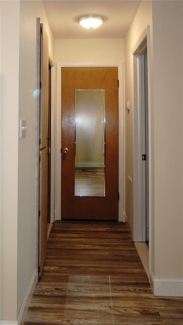 4349 Tahitian Gardens Cir Unit G, Holiday, FL 34691 - hallway featuring wood finished floors and baseboards