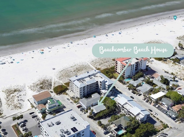 bird's eye view with a water view and a beach view