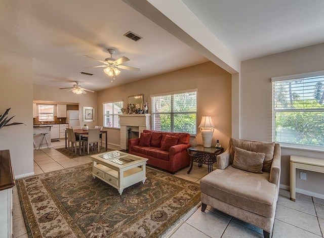 living room with ceiling fan and light tile patterned flooring