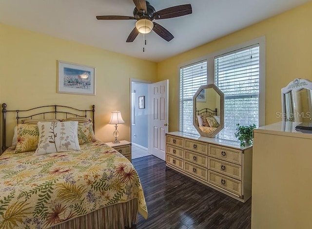 bedroom with ceiling fan and dark hardwood / wood-style flooring