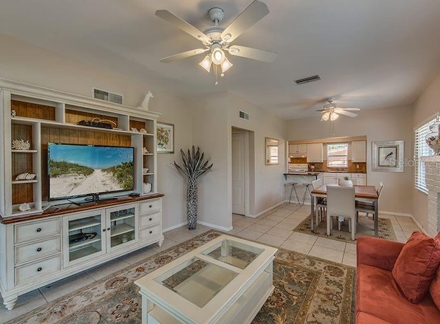 living room featuring ceiling fan and light tile patterned floors