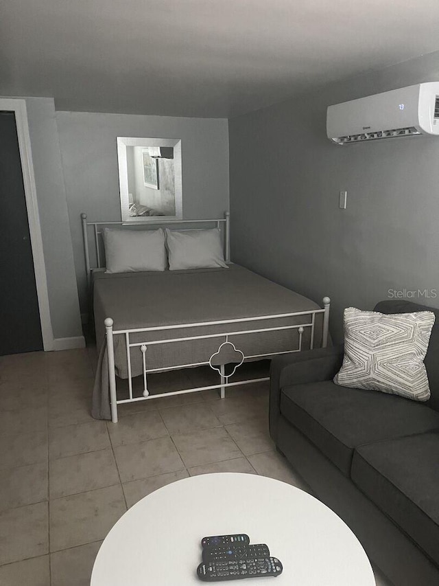 bedroom with tile patterned flooring and a wall mounted AC