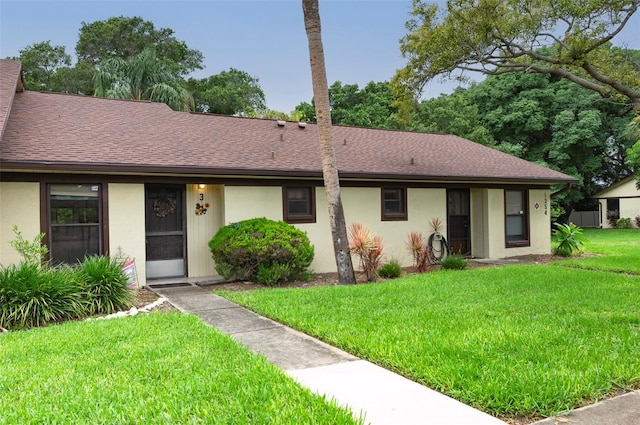 ranch-style home featuring a front yard