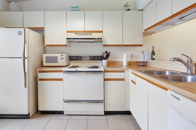 kitchen featuring white cabinetry, light tile patterned flooring, white appliances, and sink