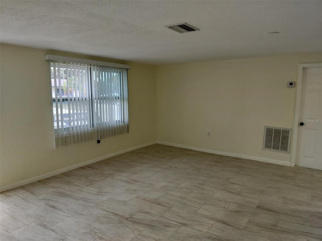 spare room featuring light tile patterned flooring