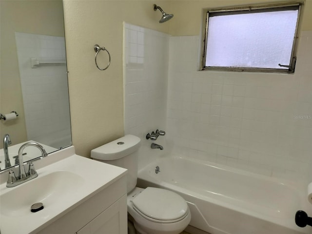 full bathroom featuring vanity, tiled shower / bath combo, and toilet