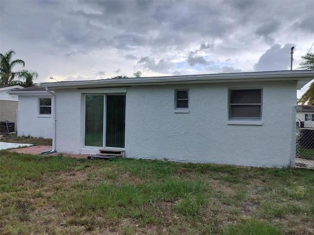 rear view of house featuring a lawn