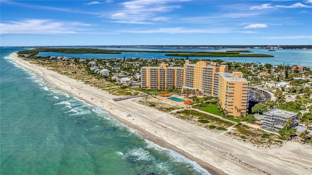 drone / aerial view featuring a water view and a beach view