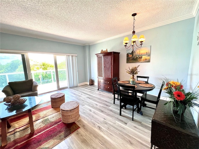 living room with ornamental molding, a chandelier, a textured ceiling, and light wood-type flooring