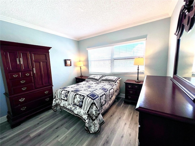 bedroom featuring a textured ceiling, wood finished floors, and crown molding