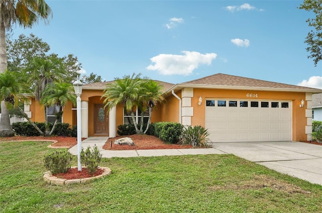 view of front facade featuring a garage and a front lawn