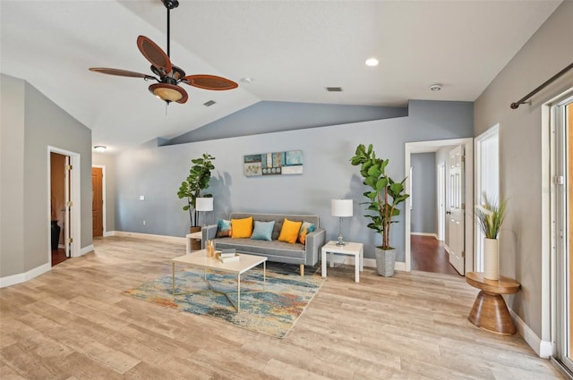 living room featuring ceiling fan, light wood-type flooring, and lofted ceiling