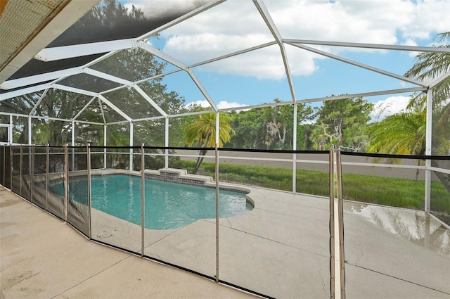 view of swimming pool with a patio area and a lanai