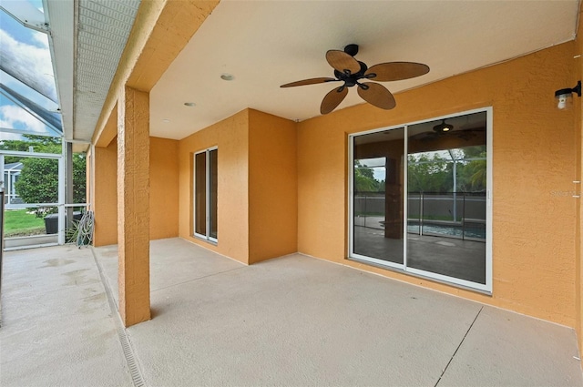 view of patio featuring ceiling fan and a lanai