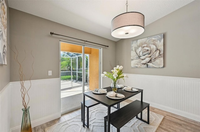 dining area featuring light hardwood / wood-style floors and a textured ceiling