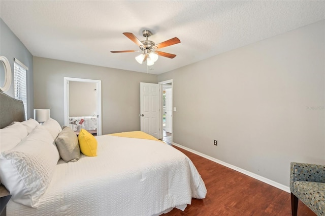 bedroom featuring ceiling fan, dark wood-type flooring, and a textured ceiling