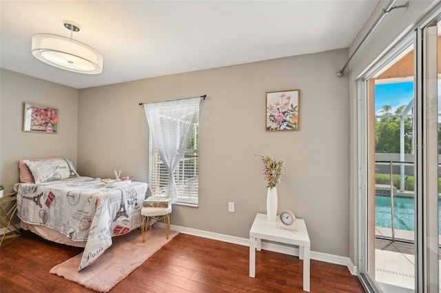 bedroom featuring access to exterior and hardwood / wood-style flooring