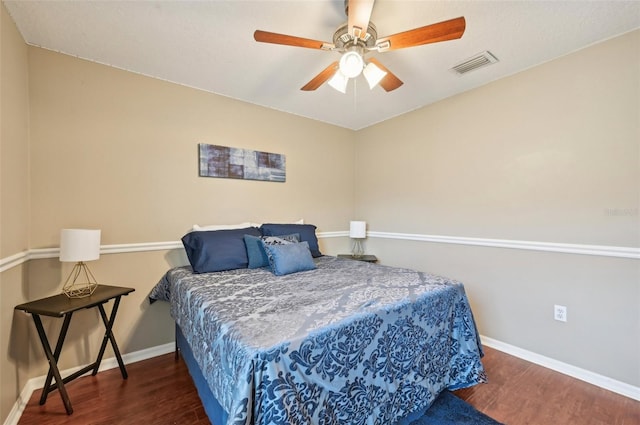 bedroom with ceiling fan and dark hardwood / wood-style floors