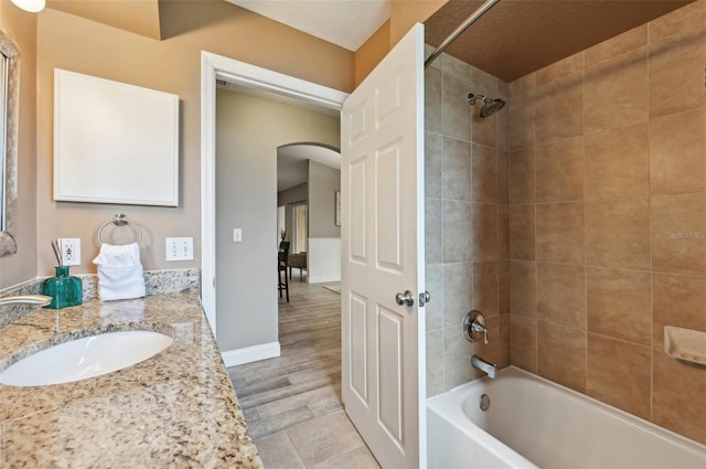 bathroom featuring vanity and tiled shower / bath