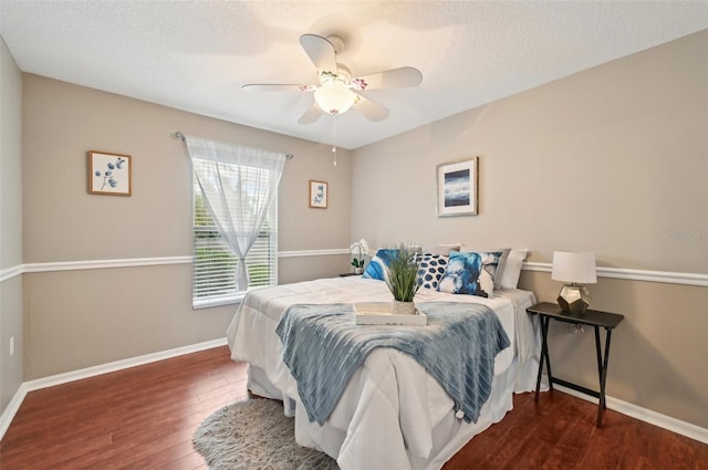 bedroom featuring a textured ceiling, dark hardwood / wood-style flooring, and ceiling fan