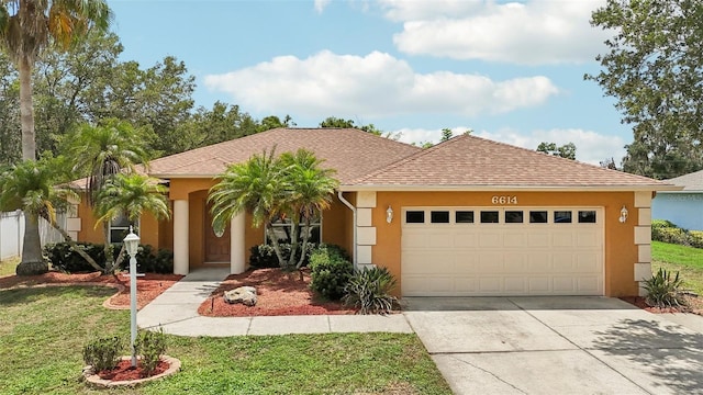 view of front of property with a front lawn and a garage