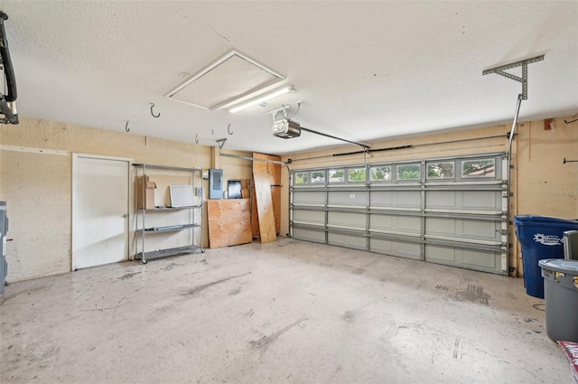 garage featuring electric panel and a garage door opener