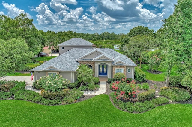 view of front of house with french doors and a front yard