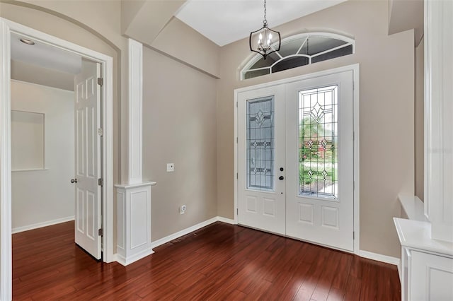 foyer entrance with a chandelier, french doors, and dark hardwood / wood-style flooring