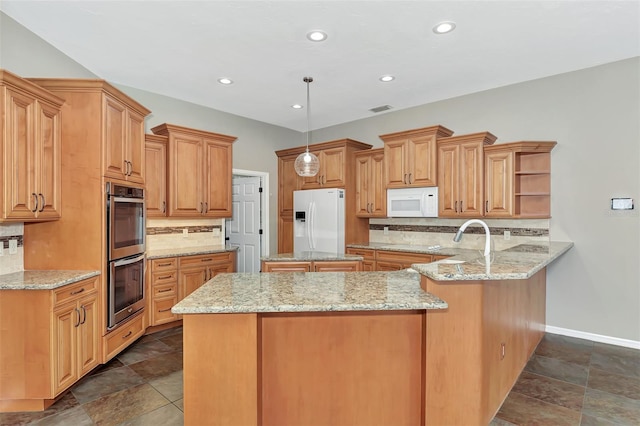 kitchen featuring light stone countertops, backsplash, kitchen peninsula, decorative light fixtures, and white appliances