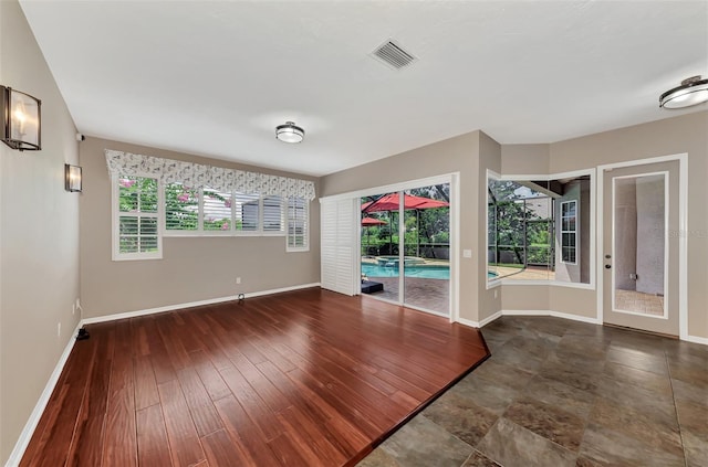 unfurnished room with dark hardwood / wood-style floors