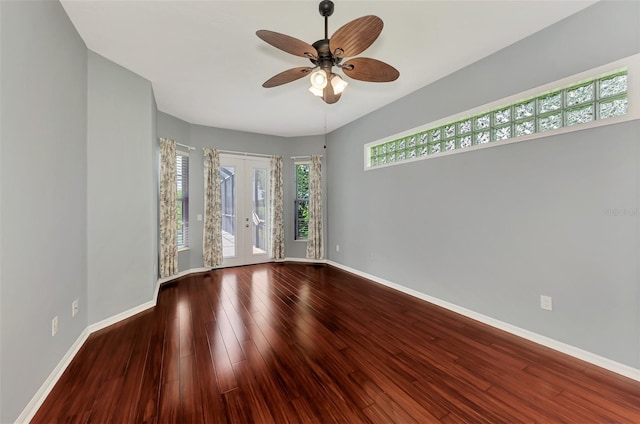 empty room featuring ceiling fan, wood-type flooring, and french doors