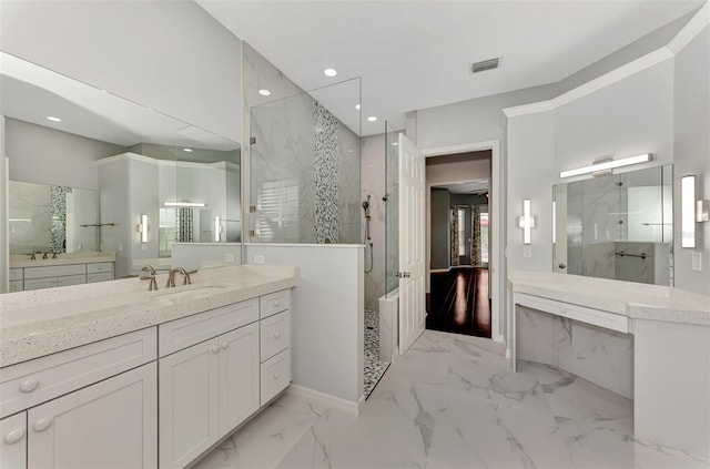 bathroom featuring vanity and tiled shower