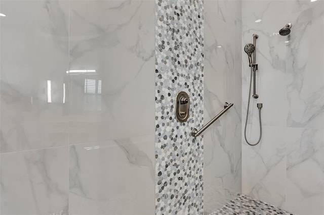 bathroom with a tile shower