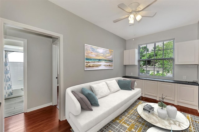 living room featuring dark hardwood / wood-style floors and ceiling fan