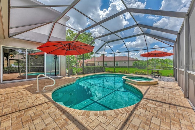 view of pool featuring a lanai, an in ground hot tub, and a patio