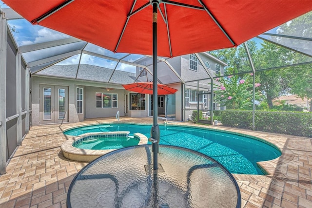 view of swimming pool with glass enclosure, an in ground hot tub, a patio, and french doors