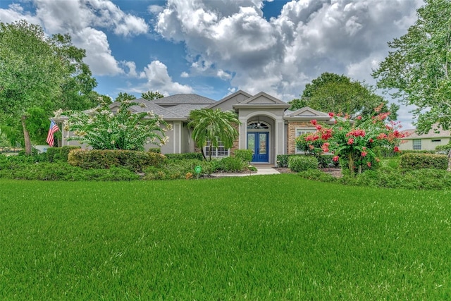 view of front of home with a front yard and french doors