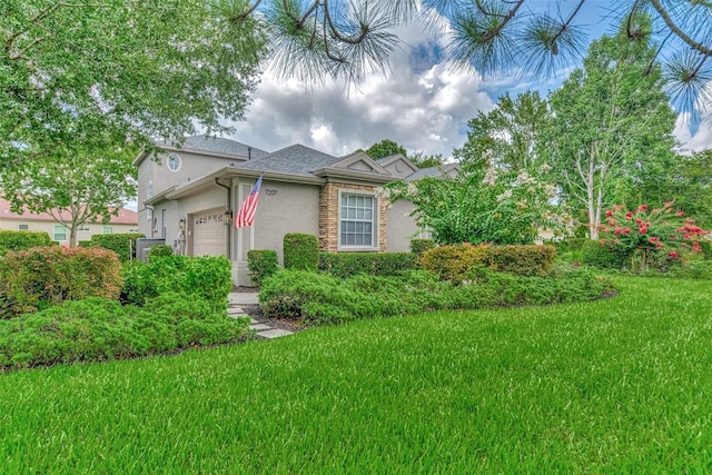 view of front of home with a garage and a front lawn