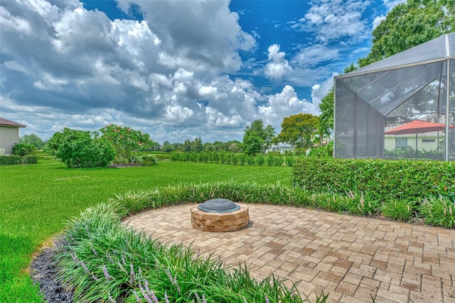 view of patio / terrace with a lanai and an outdoor fire pit