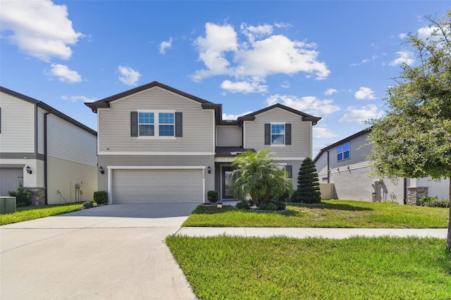 view of property featuring a front yard and a garage