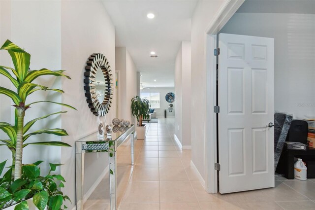 hall featuring light tile flooring