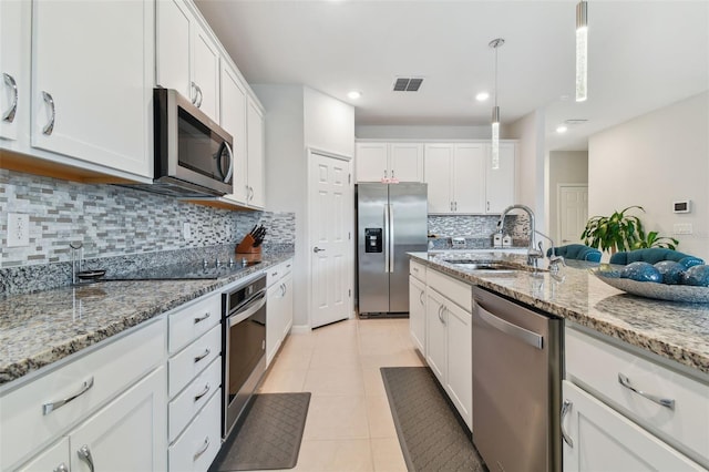 kitchen featuring sink, stainless steel appliances, tasteful backsplash, and light tile floors