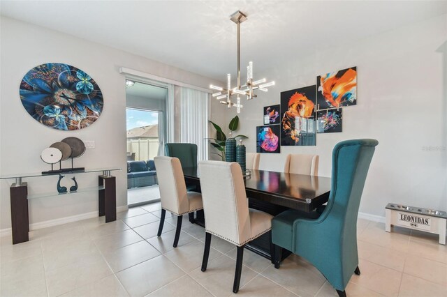 tiled dining room with a chandelier