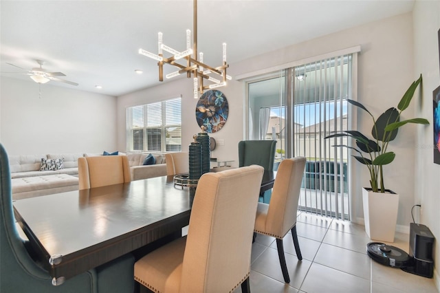 dining space with light tile floors and ceiling fan with notable chandelier