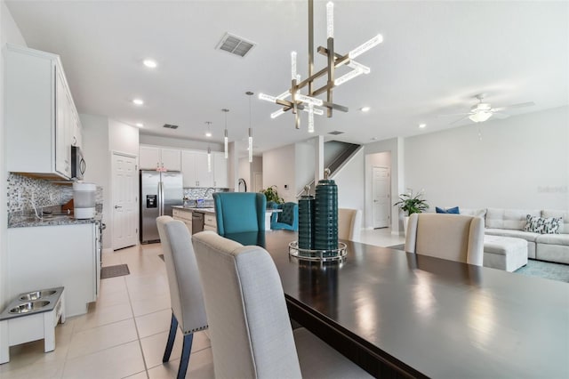 dining room with ceiling fan and light tile floors