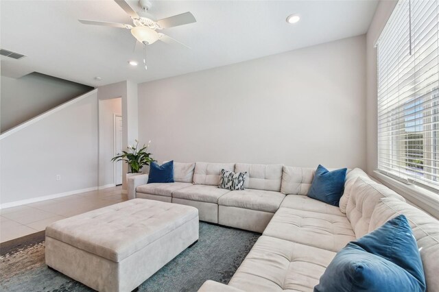 tiled living room with ceiling fan