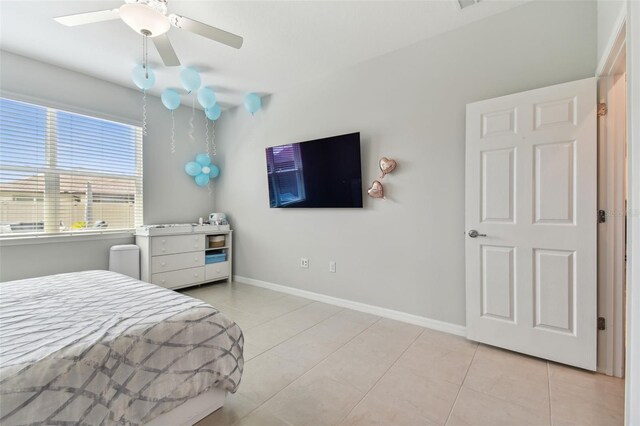 bedroom with ceiling fan and light tile floors