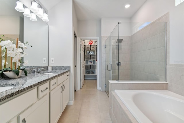 bathroom with tile floors, double sink vanity, and plus walk in shower